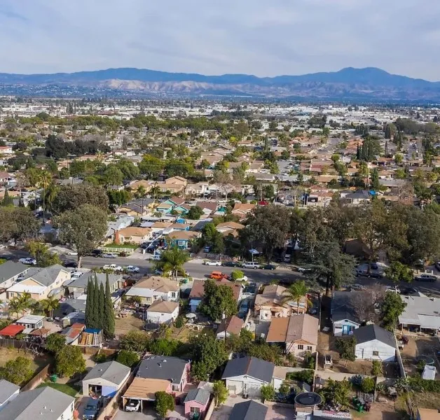 Santa Ana residential homes with palm trees and mountains in the distance