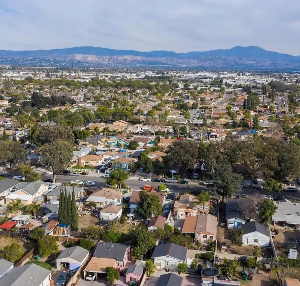 Santa Ana residential homes with palm trees and mountains in the distance